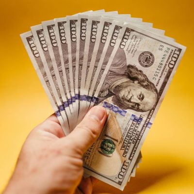 Photo by Jonathan Borba: https://www.pexels.com/photo/person-holding-an-american-dollar-bills-14820477/